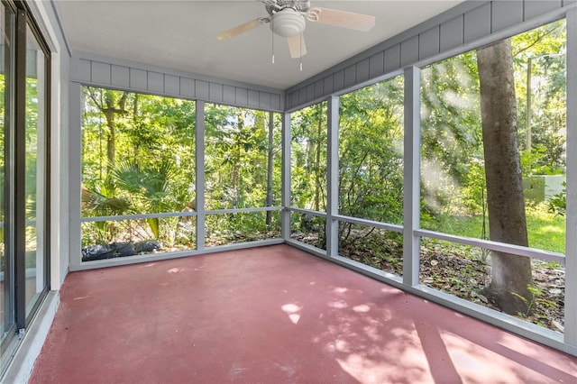 unfurnished sunroom featuring ceiling fan