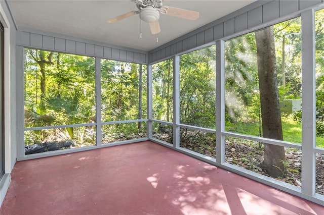 unfurnished sunroom featuring ceiling fan