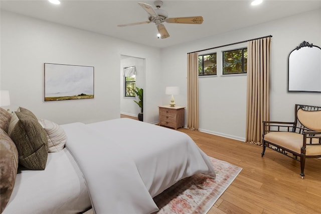 bedroom featuring multiple windows and light hardwood / wood-style flooring