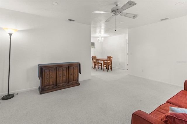 carpeted living room featuring ceiling fan