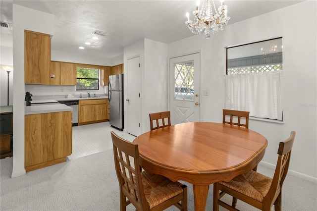 carpeted dining room with sink and a notable chandelier