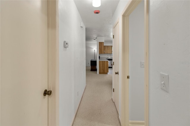 hall featuring light colored carpet