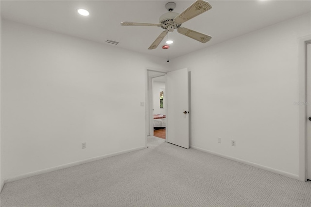 unfurnished bedroom with light colored carpet and ceiling fan