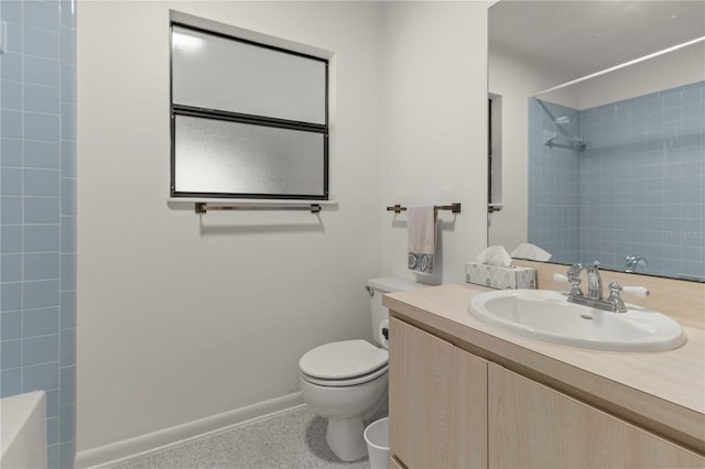 full bathroom with vanity, tiled shower / bath, and toilet