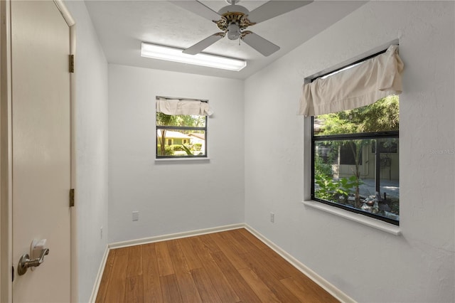 spare room with ceiling fan and hardwood / wood-style floors