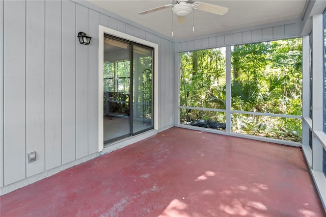 unfurnished sunroom featuring ceiling fan