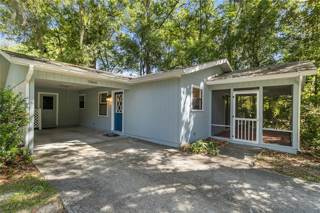 rear view of property featuring a carport