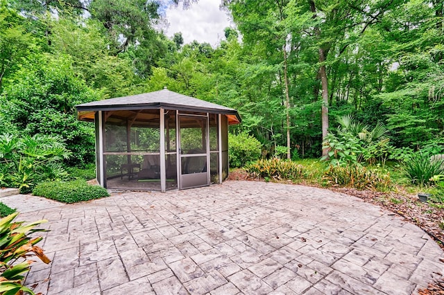 view of patio featuring a sunroom