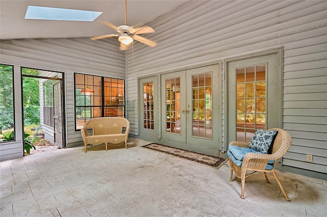 unfurnished sunroom featuring french doors, ceiling fan, and lofted ceiling with skylight