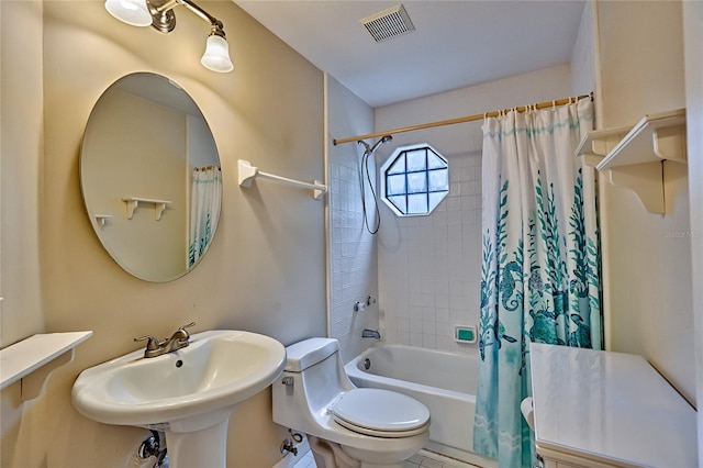 full bathroom with sink, shower / tub combo, and toilet