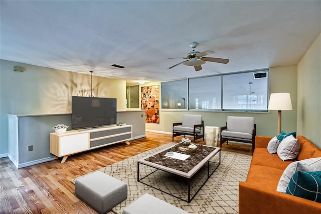 living room featuring hardwood / wood-style flooring and ceiling fan