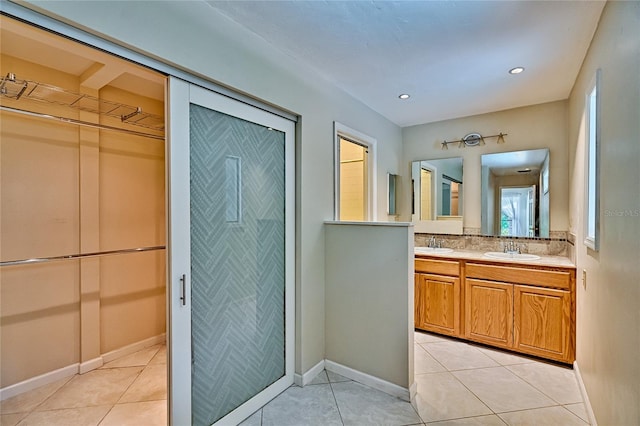 bathroom with vanity, backsplash, and tile patterned floors