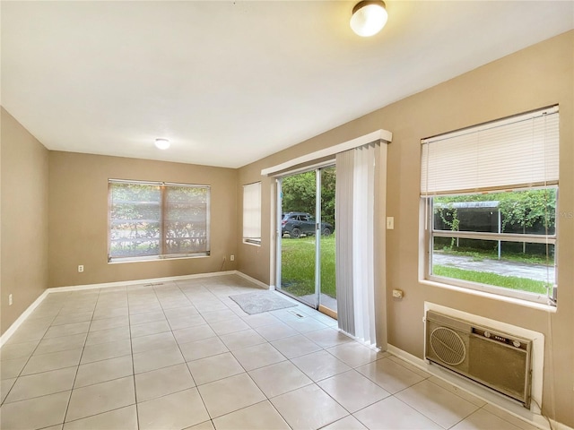 unfurnished room featuring heating unit and light tile patterned floors