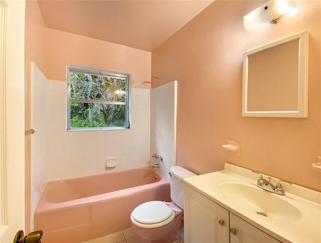 full bathroom featuring toilet, tiled shower / bath combo, vanity, and tile patterned floors