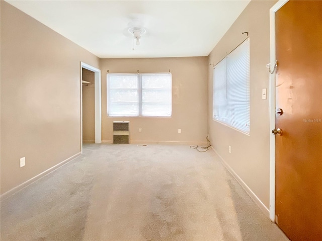 carpeted spare room featuring a wealth of natural light