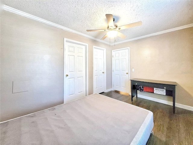 unfurnished bedroom featuring a textured ceiling, dark wood-type flooring, ceiling fan, and crown molding