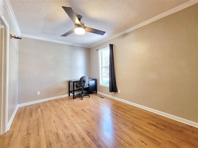 unfurnished office featuring ceiling fan, light hardwood / wood-style floors, crown molding, and a textured ceiling