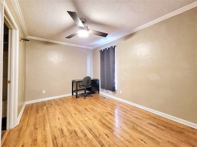 interior space featuring ceiling fan, crown molding, light wood-type flooring, and a textured ceiling