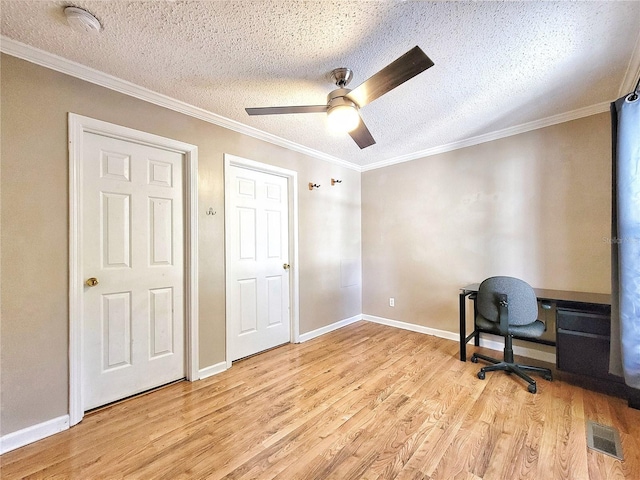 unfurnished office with ceiling fan, crown molding, a textured ceiling, and light wood-type flooring