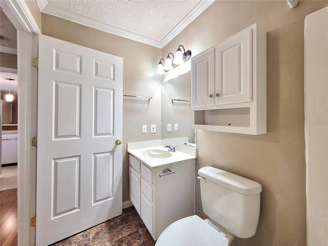 bathroom with crown molding, vanity, a textured ceiling, and toilet