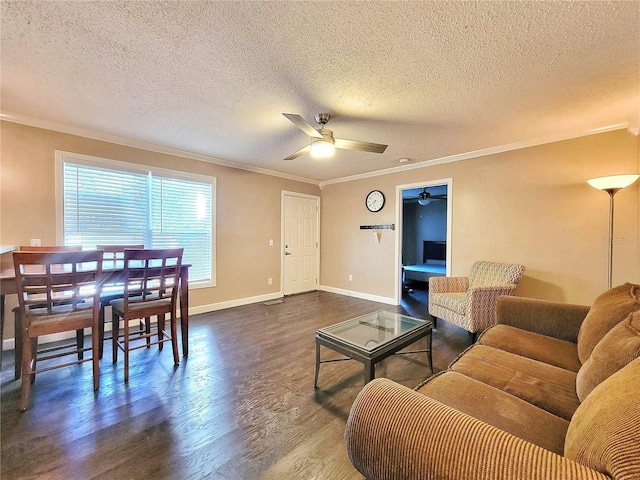 living room featuring a textured ceiling, ceiling fan, and ornamental molding