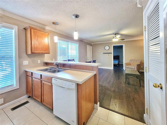 kitchen featuring ornamental molding, sink, decorative light fixtures, dishwasher, and light tile patterned flooring