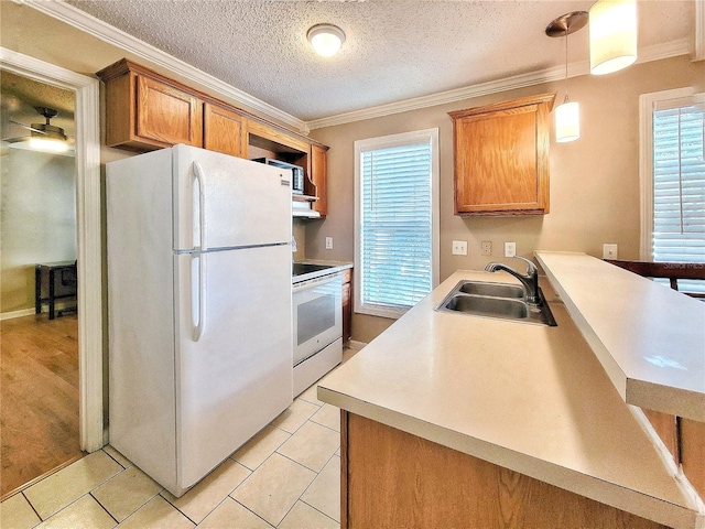 kitchen with sink, white refrigerator, decorative light fixtures, range, and light tile patterned flooring