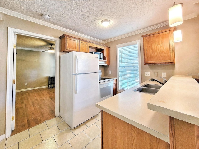 kitchen featuring stove, ceiling fan, sink, light tile patterned floors, and white fridge