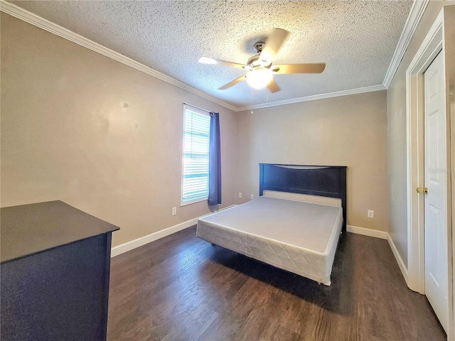 unfurnished bedroom featuring a textured ceiling, dark hardwood / wood-style floors, ceiling fan, and crown molding