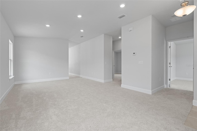 unfurnished room with light carpet