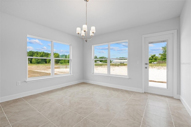 unfurnished dining area featuring light tile patterned flooring and a chandelier