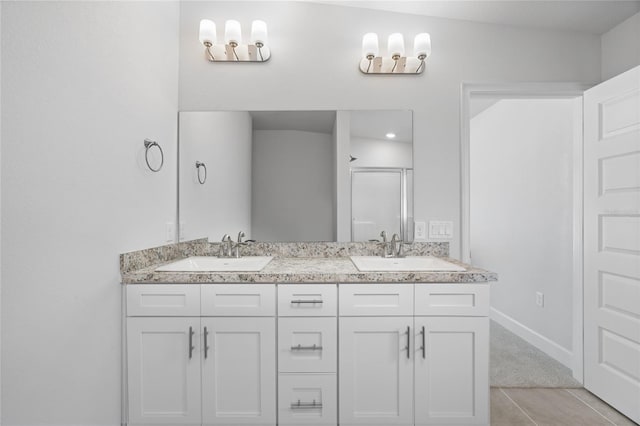 bathroom featuring tile patterned floors, vanity, and walk in shower