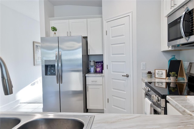 kitchen with white cabinetry and appliances with stainless steel finishes