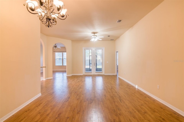 spare room with wood-type flooring, french doors, and a chandelier