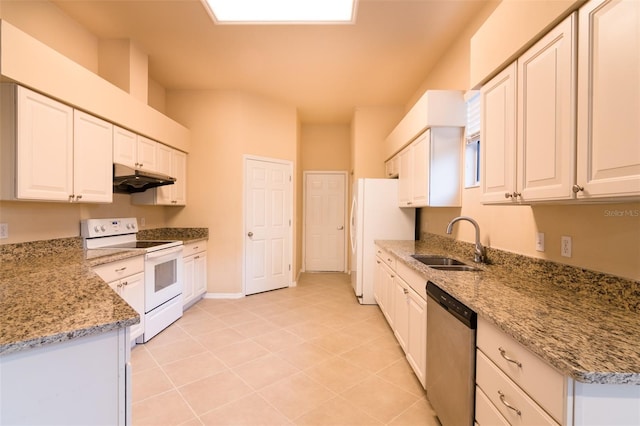 kitchen featuring light stone counters, sink, white cabinets, and white appliances