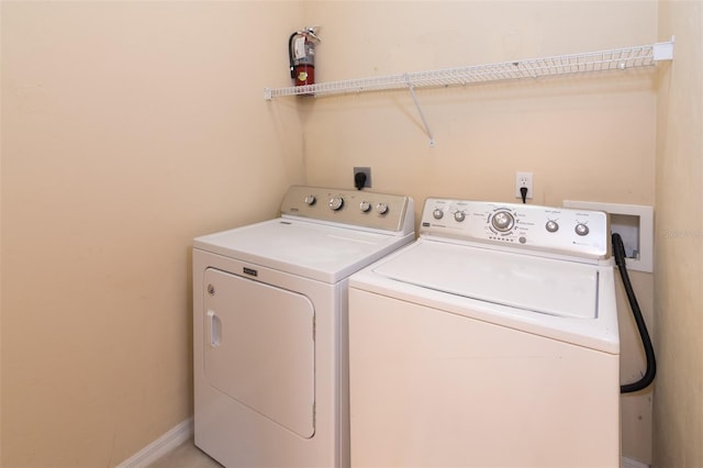 clothes washing area with washer and dryer