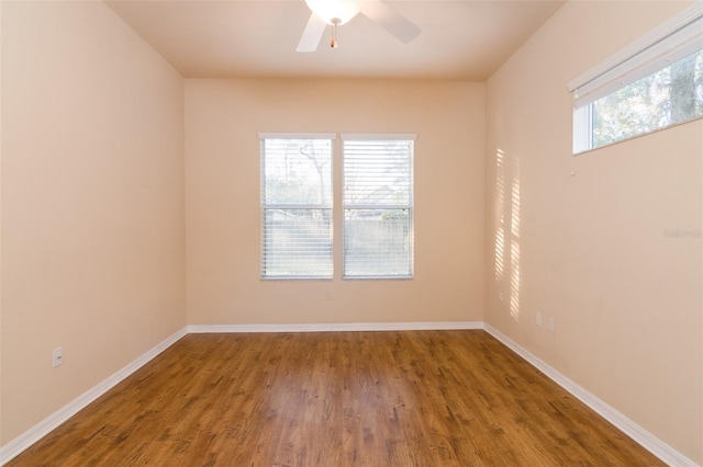 spare room with hardwood / wood-style floors, ceiling fan, and a wealth of natural light