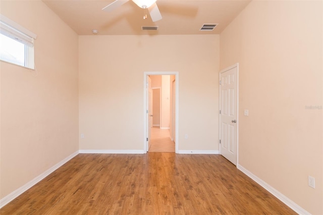 spare room featuring ceiling fan and light hardwood / wood-style floors