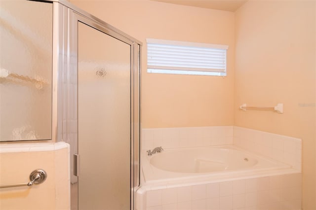 bathroom with shower with separate bathtub