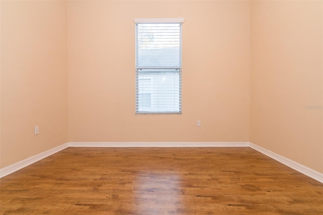 spare room with hardwood / wood-style floors