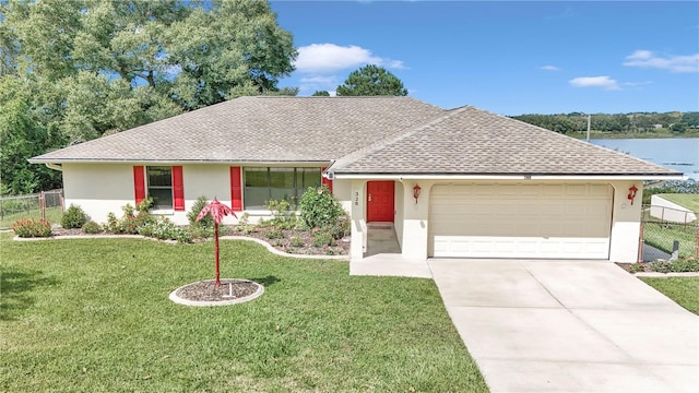 ranch-style home featuring concrete driveway, a garage, a front lawn, and stucco siding