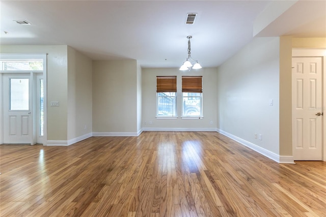 interior space featuring light hardwood / wood-style flooring and a chandelier