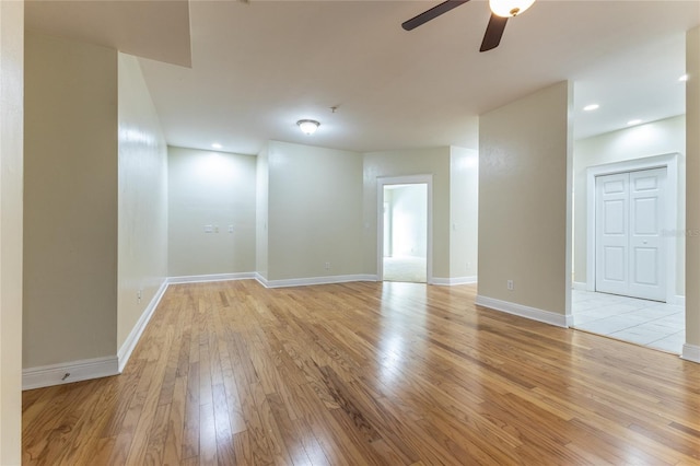 spare room featuring ceiling fan and light wood-type flooring