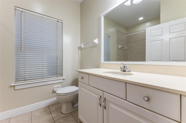 bathroom featuring tile patterned flooring, vanity, tiled shower, and toilet