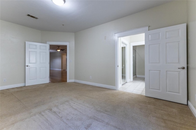 unfurnished room featuring ceiling fan and light colored carpet