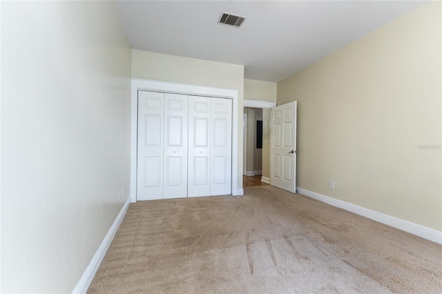 unfurnished bedroom featuring a closet and carpet floors