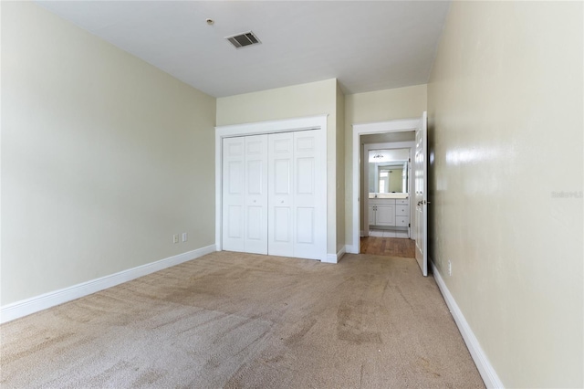 unfurnished bedroom featuring carpet floors and a closet