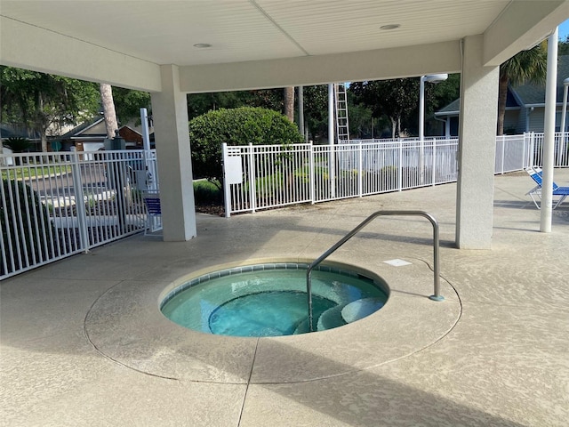 view of pool featuring a community hot tub, fence, and a patio