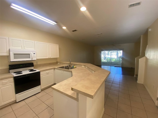 kitchen with white appliances, white cabinetry, a kitchen island with sink, and sink