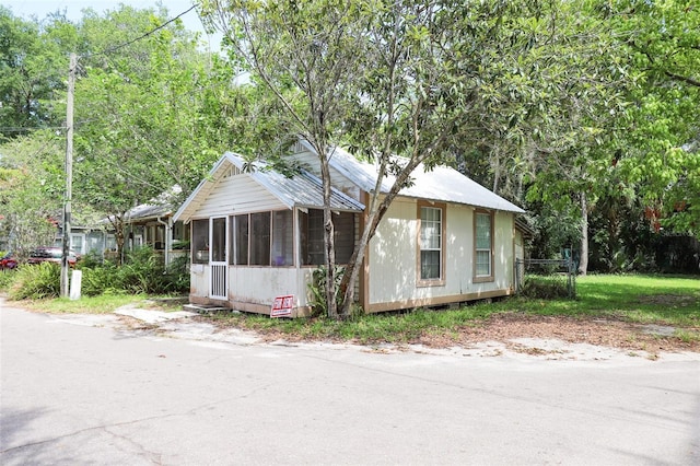 view of front of property featuring a sunroom